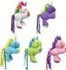 An assortment of five 4-inch Multipet plush unicorn cat toys shown against a white background in white, purple, blue, green, and pink colors, each featuring a fuzzy mane and long, colorful curly ribbon tails.