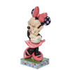 Front left angle view of the Disney Traditions Minnie Mouse Holding Bunny Figurine by Jim Shore, 6011918.