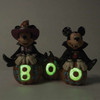 Alternate front glow in dark view of the Disney Traditions by Jim Shore 'Cutest Pumpkins in the Patch' Mickey & Minnie Halloween Figurine, 6013052.