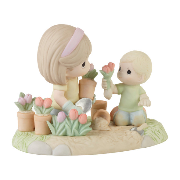 Front right angle view of the Precious Moments A Mother's Love Makes a Garden Grow Boy Figurine, 223011.