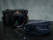 black and blue leather braided camera strap.