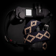 Adjustable black and blue leather camera strap on a Leica SL II