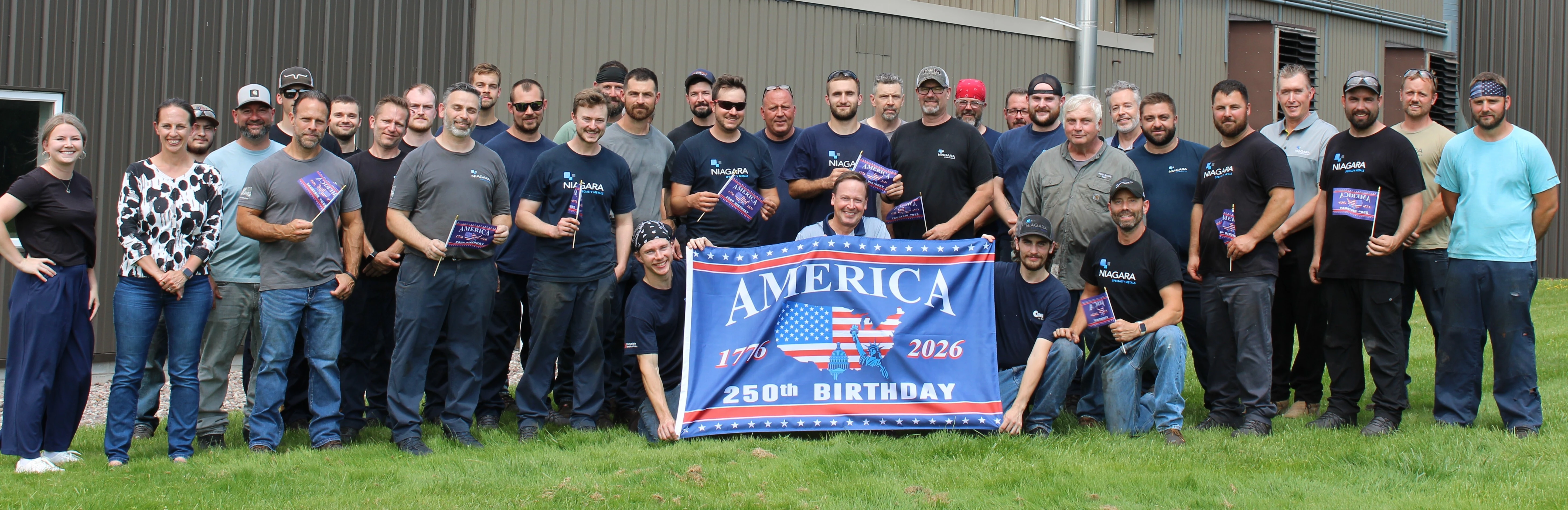 Niagara Specialty Metals employee-owners standing together outside of the specialty steel manufacturing facility in Akron, New York