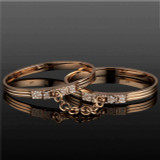 triple secure oath handcuff bangles in 18 karat rose gold with pave diamond accents on the latches; double cuff bracelet