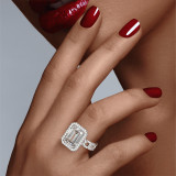 Emerald-Cut Halo Engagement Ring with a Diamond Platinum Band on hand