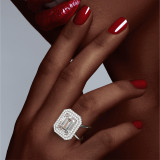Emerald Cut Diamond Double Halo Ring with a Platinum Axis Setting on hand