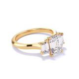 EMERALD CUT DIAMOND ENGAGEMENT RING WITH A TRAPEZOID FLANK THREE PHASES SLIM SETTING IN 18K YELLOW GOLD