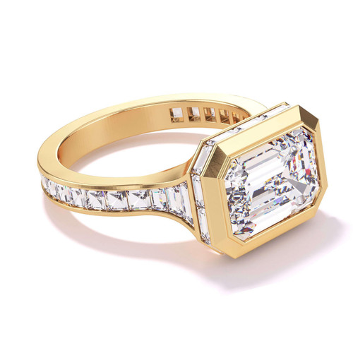 East west emerald cut ring with side baguettes in yellow gold