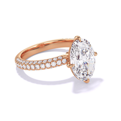 oval solitaire engagement ring in rose gold on a pave band