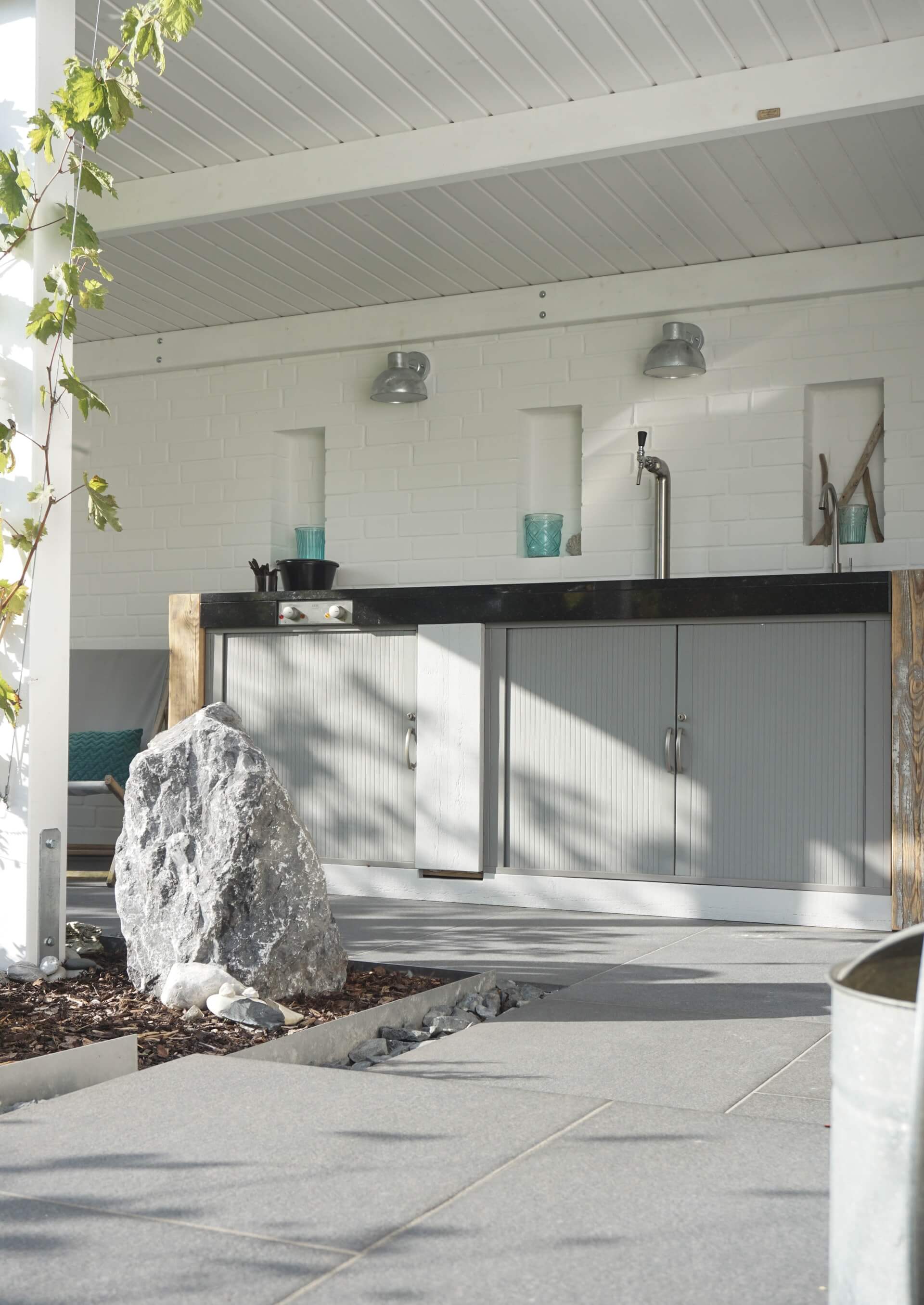 High-end, luxury white outdoor kitchen with grey cabinets