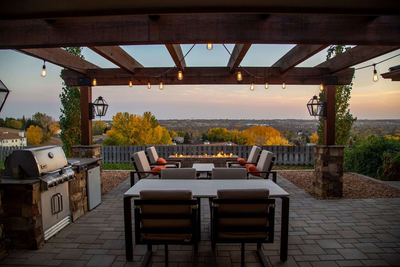 Patio at sunset with a grill, outdoor appliances, and firepit