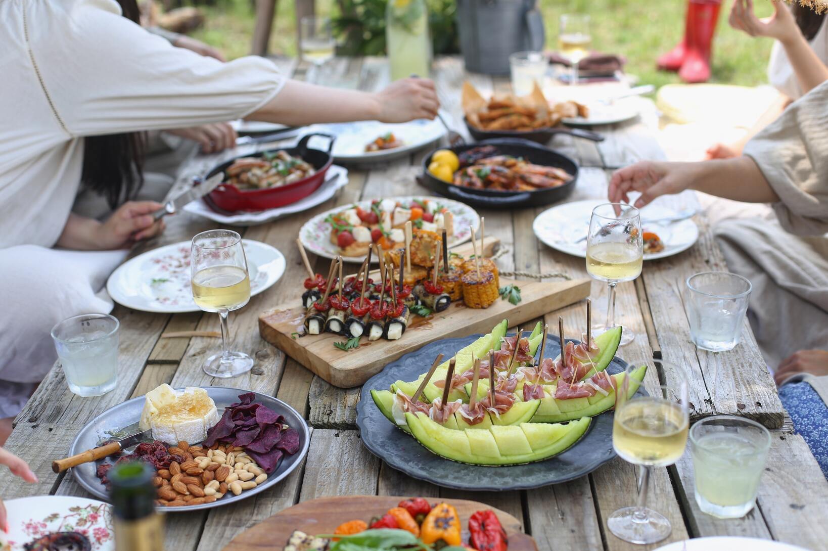 People enjoying a meal on a wooden table