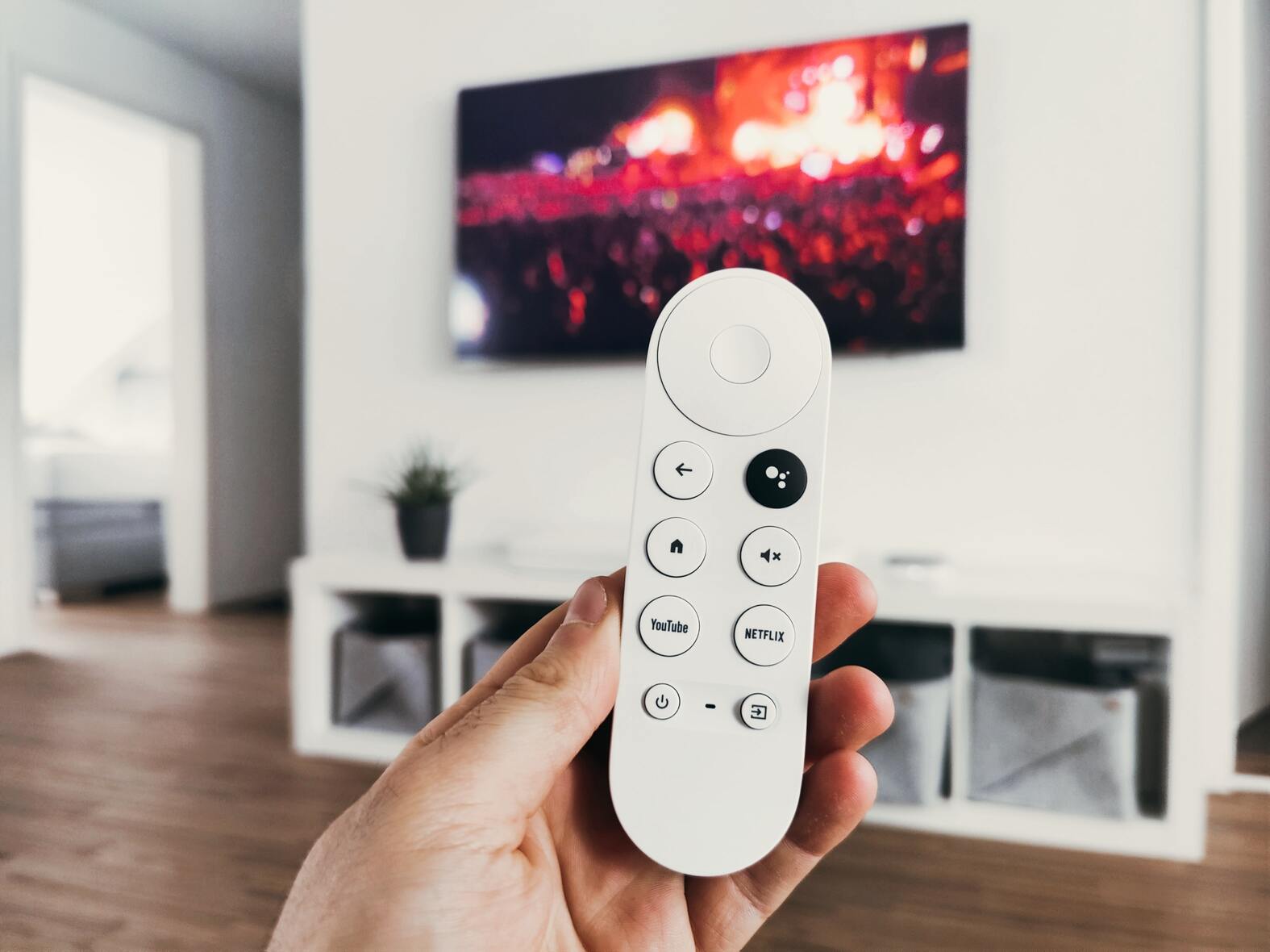 Person holding a controller in front of a TV