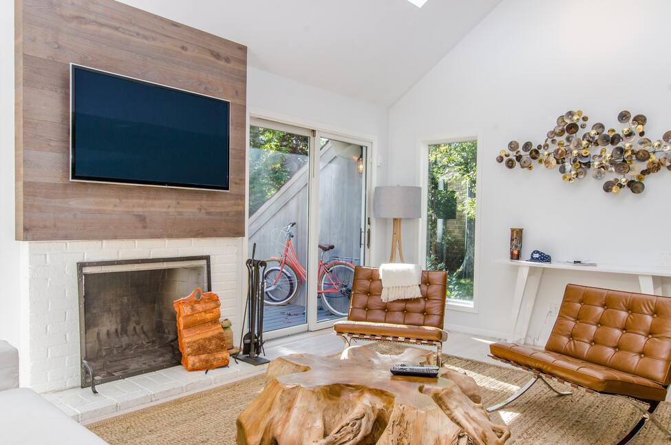 Photo of a living room with a TV above a fireplace