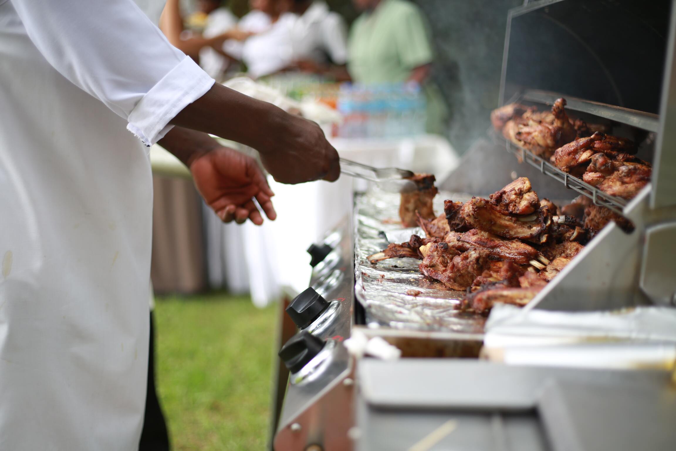 Photo of a person grilling meat