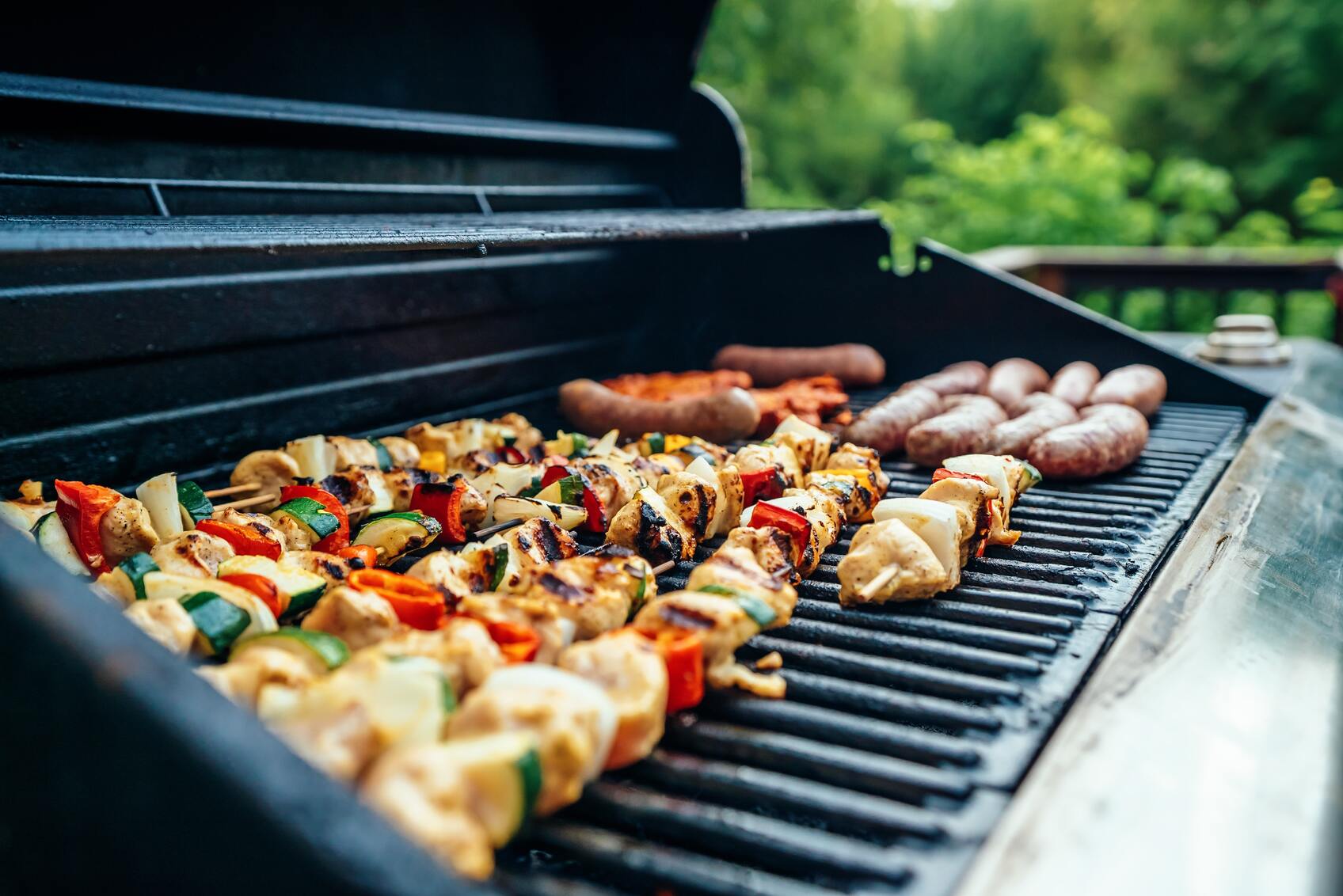 Skewers and sausages on a grill