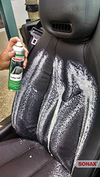 Spraying SONAX Leather Foam