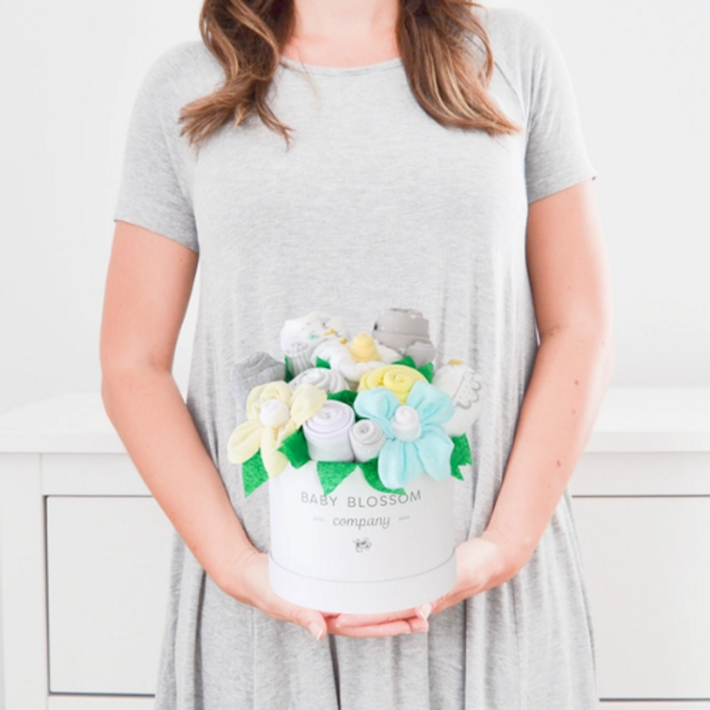 Celebrate the new mom or mom-to-be in the best way possible with flowers that are practical and oh-so-adorable.  The blooms: 1 bodysuit 1 bib 1 burp cloth 3 washcloths 3 pairs of socks, Sized 0-3months. Available in 3 unique collections - Neutral Baby Animals, Pink Ballerina, Blue Fox