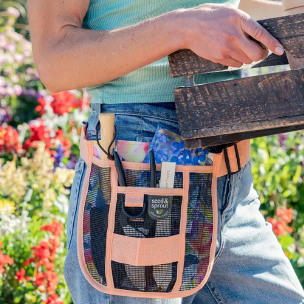 Perfect gift for the gardening enthusiast. This gift features a durable canvas, adjustable tool belt with mesh pockets, D-ring and utility loop to perfectly fit hand tools, seed packets, twine and small items. Along with the gardening belt, your gift includes a pair of gloves, 2 assorted seed packets, a hazelnut butter cream chocolate bar, CURE hydrating electrolyte drink mix, Gardener's Hand scrub and Hand Therapy Cream. Created in a unique metal planter with decorative gardening tools.