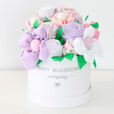 Celebrate the new mom or mom-to-be in the best way possible with flowers that are practical and oh-so-adorable.  The blooms: 1 bodysuit 1 bib 1 burp cloth 3 washcloths 3 pairs of socks, Sized 0-3months. Available in 3 unique collections - Neutral Baby Animals, Pink Ballerina, Blue Fox