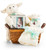 A charming basket is filled with a plush lamb, velvet rattle and keepsake picture frame to capture those special moments.