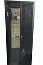 A straight-on view of the closed, split-vertical perforated mesh rear doors of a black APC server rack enclosure