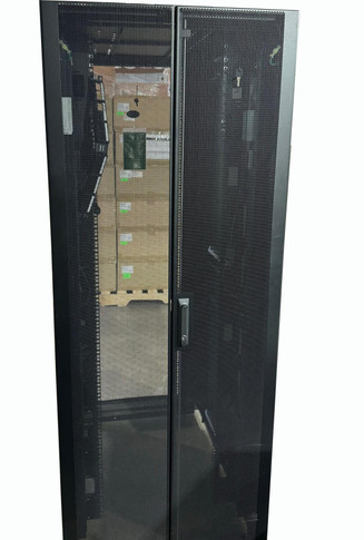 A straight-on view of the closed, split-vertical perforated mesh rear doors of a black APC server rack enclosure