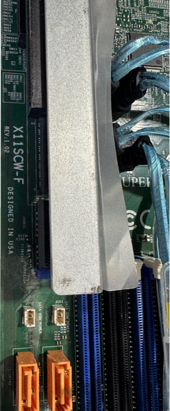 Zoomed-in photo inside the chassis showing the model of the motherboard