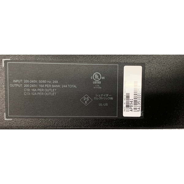 Close-up view of the product specification sticker and barcode label on an APC AP8941 Rack PDU, displaying input/output voltage ratings, model number, and serial number.