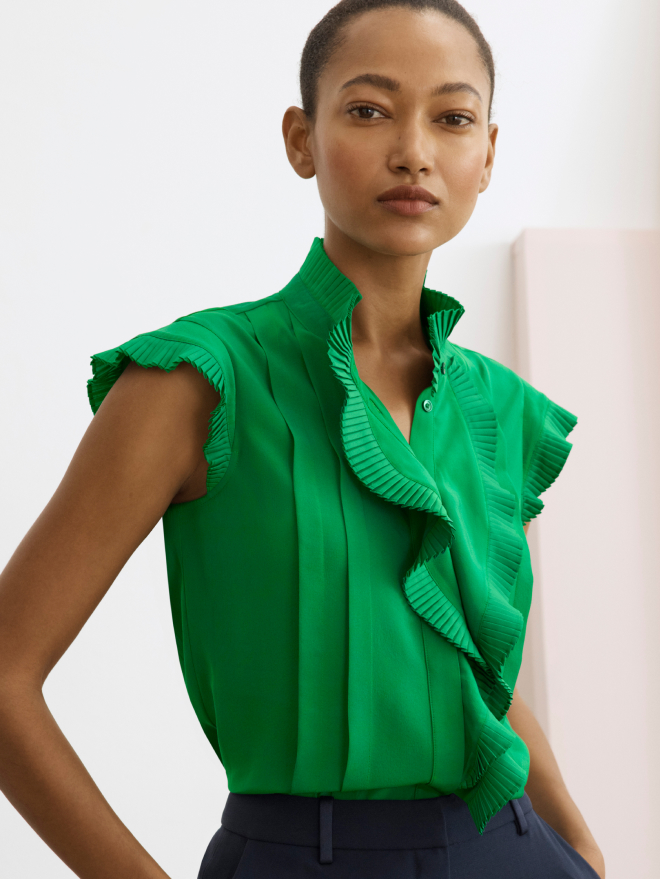 Model wearing emerald green Symons sleeveless blouse