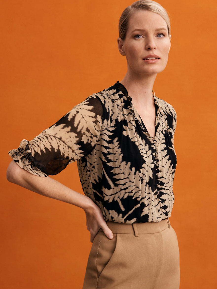 Model wearing sand fern print Tierney blouse