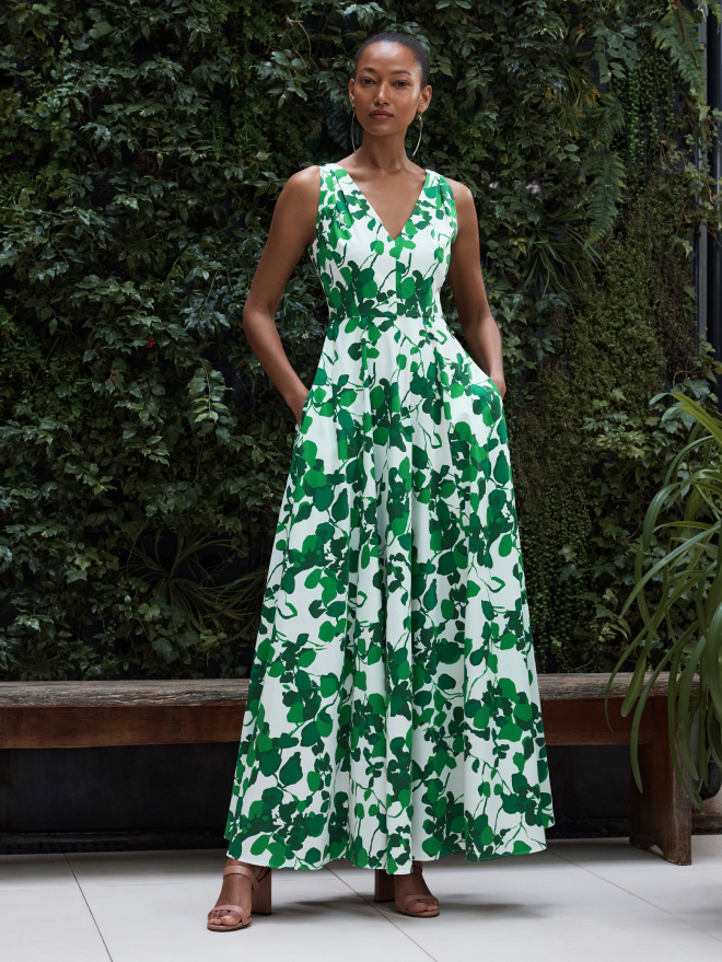 Model wearing ivory and green Almeria maxi dress