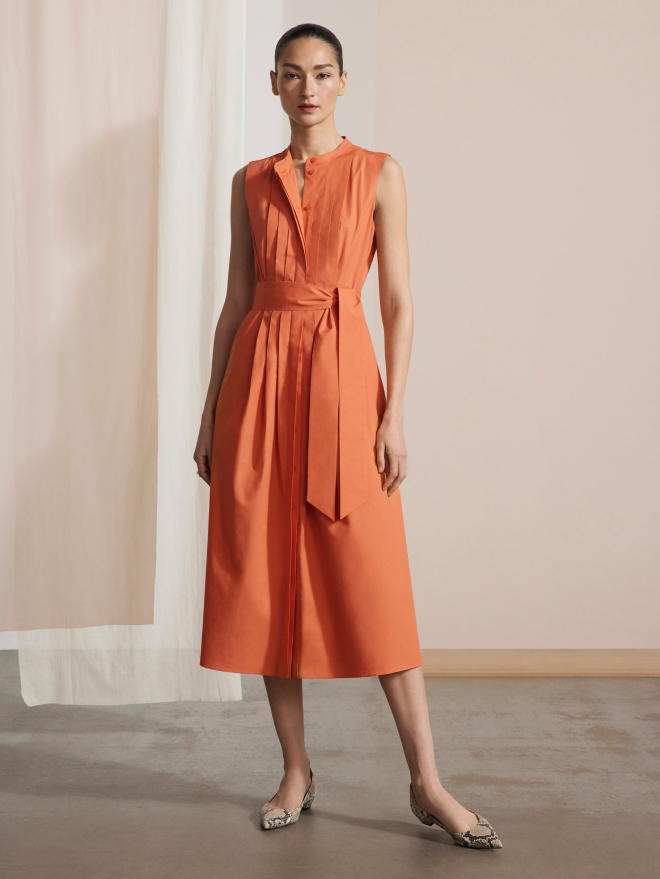 Model wearing summer orange Lavenham dress