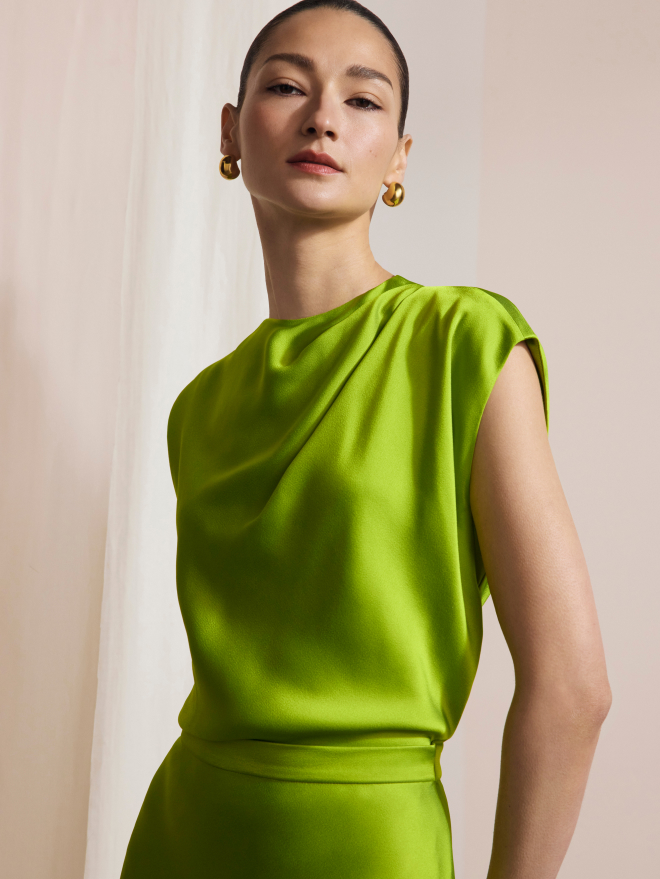 Model wearing vivid lime green Skye top