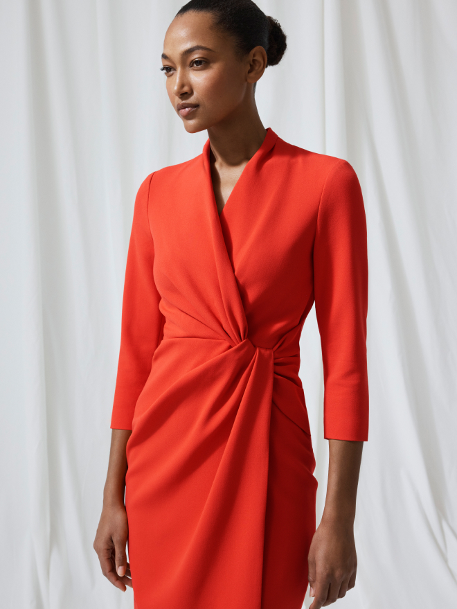 Model wearing vivid orange Greenwich dress