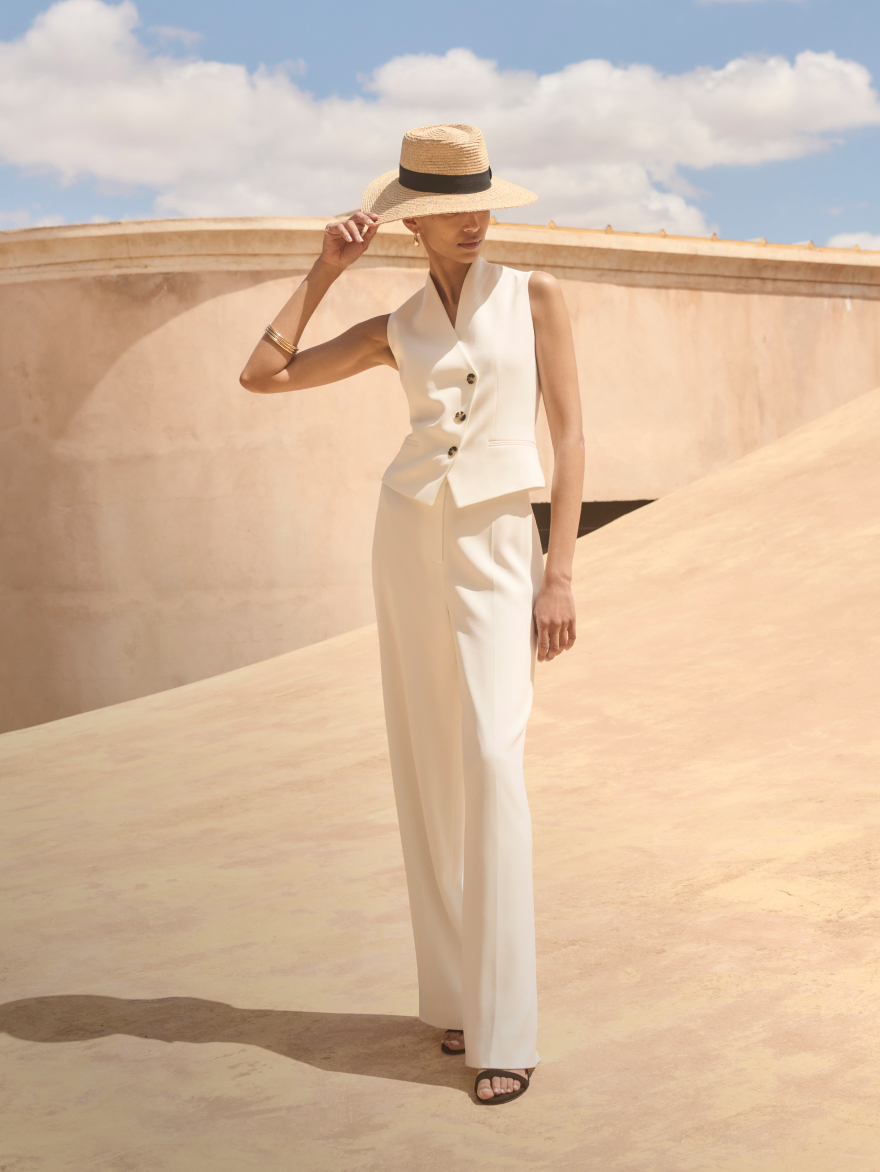 Model wearing ivory tailoring