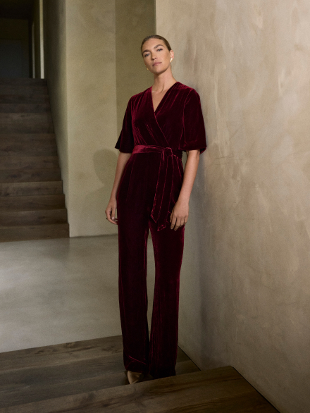 Model wearing red velvet Langford jumpsuit