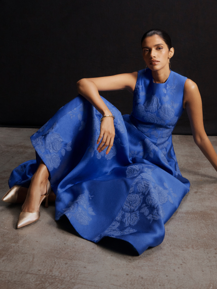 Model wearing blue Adria dress
