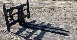 Side view of the Haugen MWPH 96 pipe fork attachment for heavy-duty material handling.