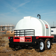 Wide-angle image of the trailer in a jobsite environment, presenting the full unit ready for water transport and spray operations.
