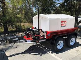 Zoomed-in view of the trailer tires and suspension, emphasizing the heavy-duty wheels and spring components.