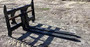 Side view of the Haugen MWPH 96 pipe fork attachment for heavy-duty material handling.