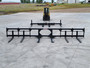 Haugen MDH-144-FS Fork Spreader THE DOOHICKEE for telehandlers featuring a 92-inch base unit, 12-foot spread, adjustable fork pockets, swing or non-swing fork tines, and a 10,000 lb lifting capacity.