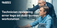 Technician reviewing error logs on dual screen workstation
