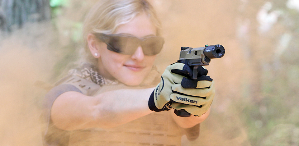 Bella of Valken Airsoft shooting Valken Hicapa airsoft pistol wearing Valken Bravo Gloves