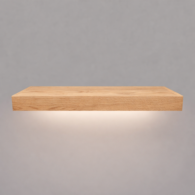 Front view of a 2-inch thick red oak floating shelf with battery-powered LED downlighting in an unfinished look, showing natural grain detail, raw wood texture, and an illuminated underside.
