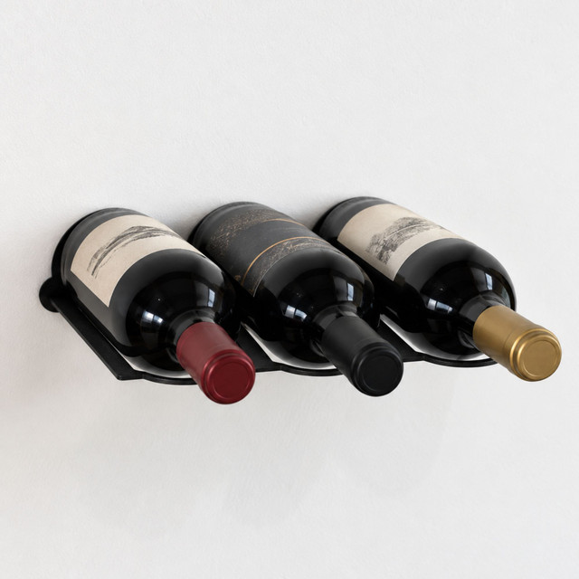 Powder-coated black wall-mounted wine rack holding three wine bottles horizontally against a light wall.