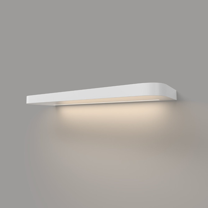 Angled view of a 1.625-inch thick white painted floating shelf with LED lighting and rounded front corners, mounted on a wall with a soft underglow.