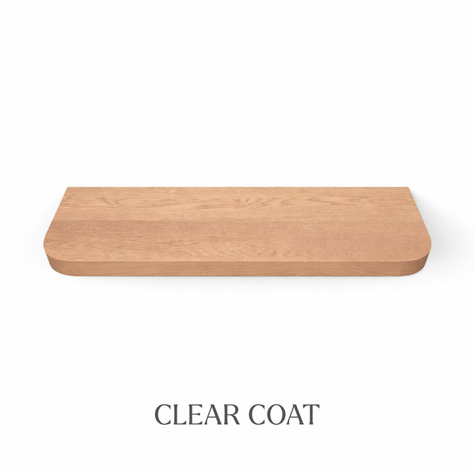 Top view of a radius-corner red oak floating shelf, finished with clear coat, showing natural grain detail and color variation.