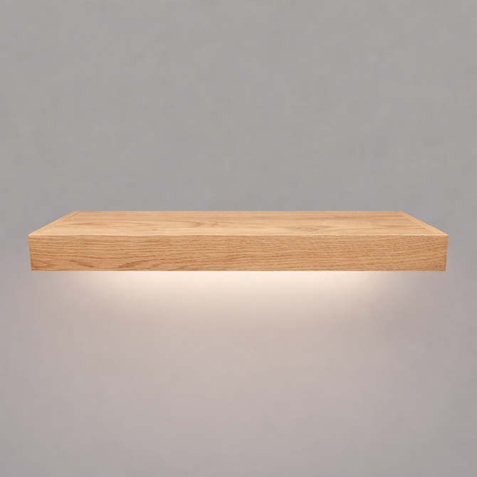 Front view of a 2-inch thick red oak floating shelf with battery-powered LED downlighting in an unfinished look, showing natural grain detail, raw wood texture, and an illuminated underside.